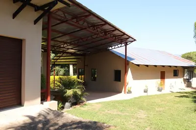 a building with awning on the side of it at The Goat House Farmstay in Nelspruit