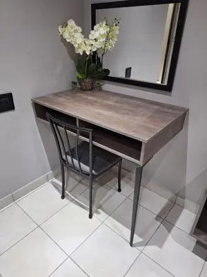 a wooden table with a chair and a mirror at 14a on Middle Way in Tzaneen