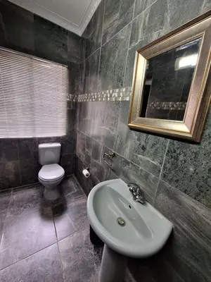 a bathroom with a sink and a toilet and a mirror at 14a on Middle Way in Tzaneen
