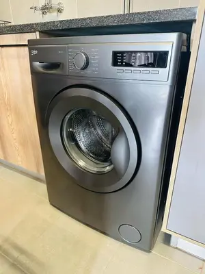 a stainless steel washing machine in a kitchen at Calm & Cozy Apartment 2 in Pretoria