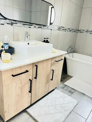 a bathroom with a sink and a tub and a toilet at The Prestige Home in Middelburg
