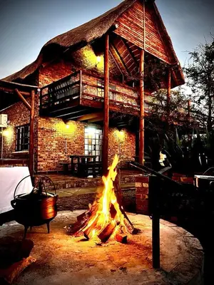 a fire pit in front of a brick building at Ingwenya View in Marloth Park