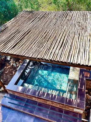 an overhead view of a swimming pool under a roof at Ingwenya View in Marloth Park