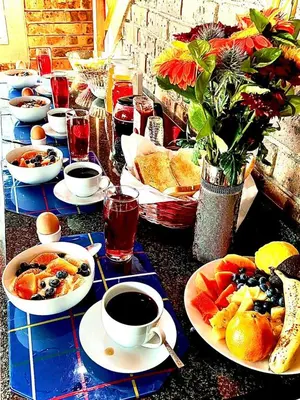 a table with plates of food and a cup of coffee at Ingwenya View in Marloth Park