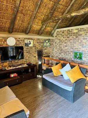 a living room with a couch and a tv at Ingwenya View in Marloth Park