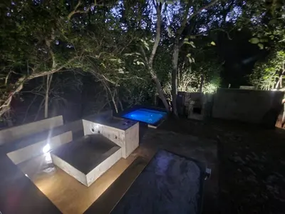 a concrete bench in a yard at night at Lazy River Retreat in Pretoria