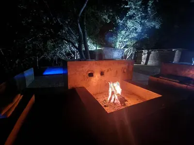 a fire pit in a yard at night at Lazy River Retreat in Pretoria