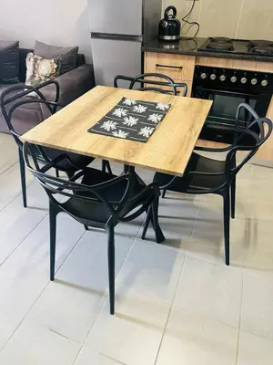 a wooden table and chairs in a kitchen at Calm & Cozy Apartment 3 in Pretoria