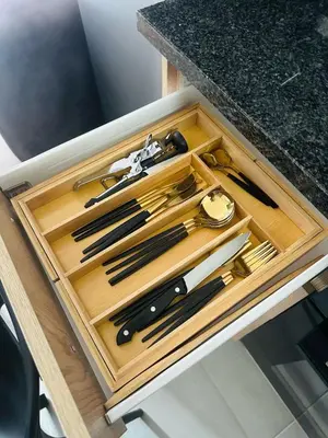 a wooden drawer with utensils on a table at Calm & Cozy Apartment 3 in Pretoria