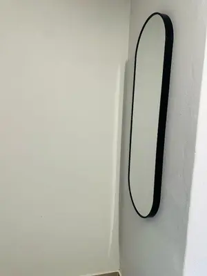 a mirror on the side of a white wall at Calm & Cozy Apartment 3 in Pretoria