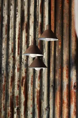 two lights hanging from a metal wall at Shiloh Bush Cottage in Nelspruit