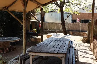 a picnic table under a pavilion in a backyard at Shiloh Bush Cottage in Nelspruit