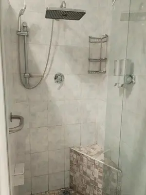 a shower with a glass door in a bathroom at Wildflower Haven in Midrand