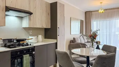 a kitchen and living room with a table and a dining room at BinBins Suite Haven in Midrand