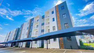 a building with a blue canopy in front of it at BinBins Suite Haven in Midrand