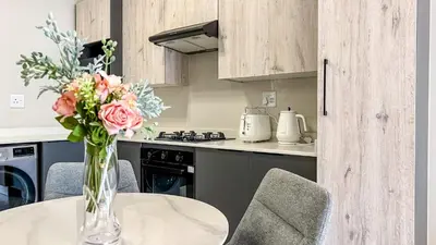a vase of flowers on a table in a kitchen at BinBins Suite Haven in Midrand