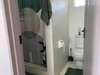 a bathroom with a toilet and a shower at Harmonie Hills in Sukani