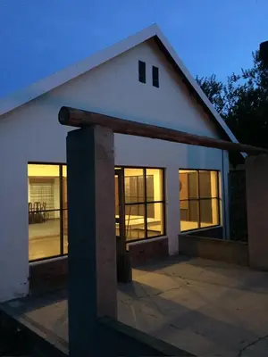 a house with large windows on the side of it at Harmonie Hills in Sukani