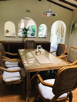 a dining room with a table and chairs at The Cosy Den in Centurion