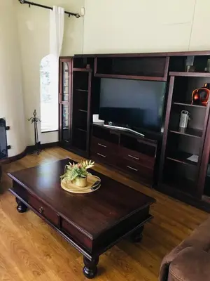 a living room with a tv and a coffee table at The Cosy Den in Centurion