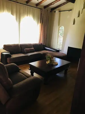 a living room with a couch and a coffee table at The Cosy Den in Centurion