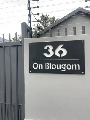 a sign on a building with the number on blossom at 36 On Blougom in Midrand