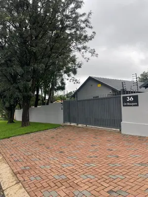 a black fence and a brick driveway at 36 On Blougom in Midrand