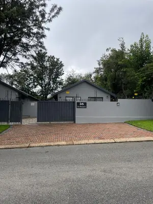 a white fence in front of a house at 36 On Blougom in Midrand