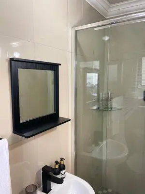 a bathroom with a sink and a glass shower at 36 On Blougom in Midrand