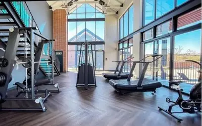 a gym with treadmills and ellipticals in a building at Ndlovu Lifestyle Apartments in Midrand