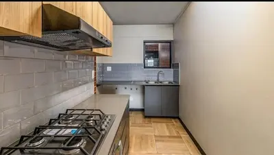 a kitchen with a stove and a sink at Ndlovu Lifestyle Apartments in Midrand