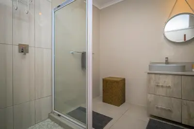 a bathroom with a shower and a sink at Bunkers Paradis at Pecanwood in Hartbeespoort