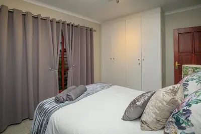 a bedroom with a bed with two pillows on it at Bunkers Paradis at Pecanwood in Hartbeespoort