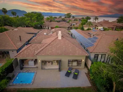 an aerial view of a house with solar panels on the roof at Bunkers Paradis at Pecanwood in Hartbeespoort