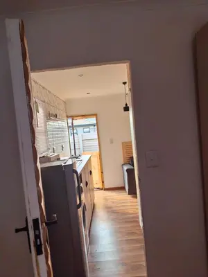 a kitchen with a refrigerator and a counter top at Cabin in Pretoria West in Pretoria