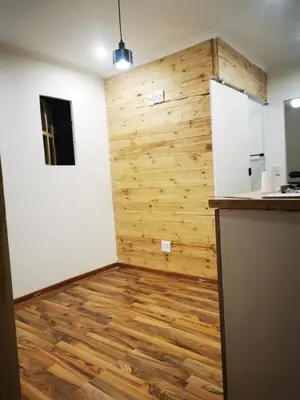 a kitchen with wooden flooring and a wall at Cabin in Pretoria West in Pretoria