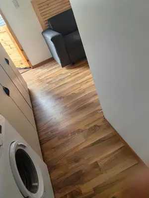 a living room with wood flooring and a couch at Cabin in Pretoria West in Pretoria