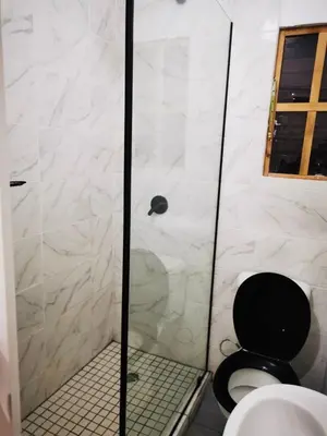 a bathroom with a shower with a toilet and a sink at Cabin in Pretoria West in Pretoria