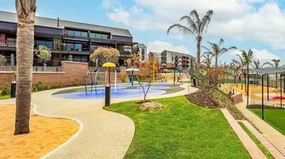 a park with a playground in front of a building at StayEase Modern Stay in Waterfall in Midrand