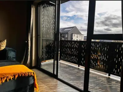 a bedroom with a view of a balcony at StayEase Modern Stay in Waterfall in Midrand