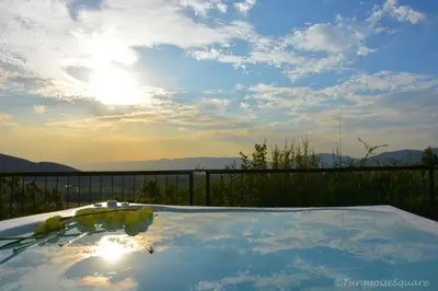 a view of the sun setting over a hot tub at La Montagne Guest Lodge in Hartbeespoort