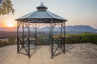 a gazebo with two chairs in it at La Montagne Guest Lodge in Hartbeespoort