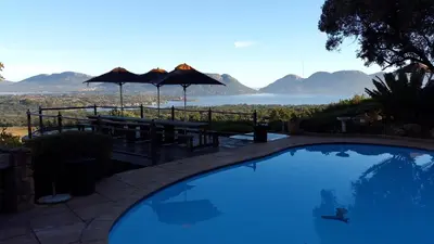 a swimming pool with a view of the ocean and mountains at La Montagne Guest Lodge in Hartbeespoort