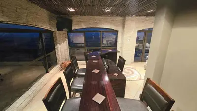 a conference room with a long wooden table and chairs at Bergendal Lodge in Hydro