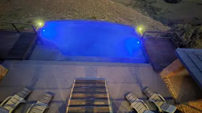an overhead view of a swimming pool at night at Bergendal Lodge in Hydro