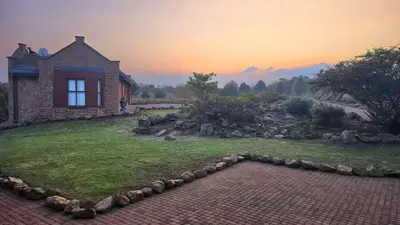 a house on a hill with a brick yard at Bergendal Lodge in Hydro