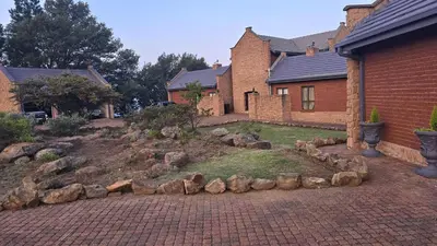 a house with a rock garden in the yard at Bergendal Lodge in Hydro