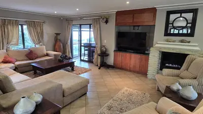 a living room with couches and a fireplace at Bergendal Lodge in Hydro
