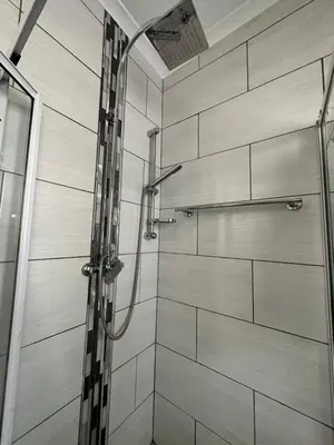 a shower with a glass door in a bathroom at Afrisky Guest House in Kempton Park