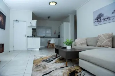 a living room with a couch and a table at Fealathome Two Bedroom in Midrand